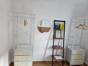 a room with white walls and a mirror and shelves at Ferienwohnung bei Meißen 