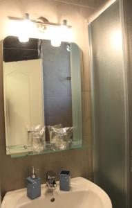 a bathroom with a sink and a mirror at Swiss Residence Montenegro in Herceg-Novi