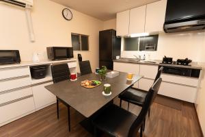 a kitchen with a table with a plate of food on it at Skytree Tokyo Residence Aoto in Tokyo