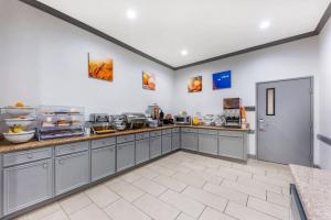 a kitchen with gray cabinets and a counter top at Comfort Inn & Suites in Schulenburg
