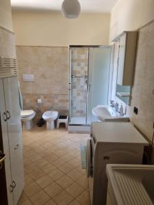 a bathroom with a toilet and a sink and a shower at La perla marina in Cellole