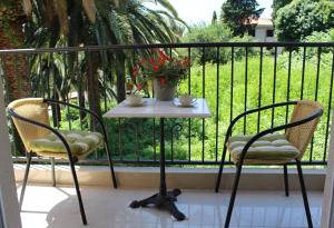 a table and two chairs on a balcony at Swiss Residence Montenegro in Herceg-Novi