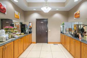 a restaurant with wooden cabinets and a food counter at Quality Inn & Suites Jefferson City in Jefferson City