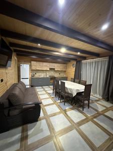 a kitchen and dining room with a table and chairs at Фазенда in Vorokhta