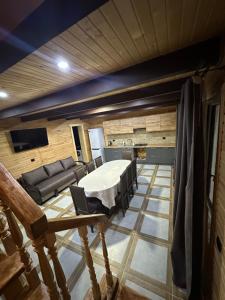 a living room with a table and a couch at Фазенда in Vorokhta +43 photos