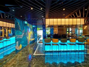 a lobby with a bar and stools at Hotel Soloha @ Chinatown in Singapore