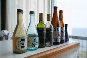 a group of bottles of wine sitting on a counter at Grand Hotel Taiyo in Shioura