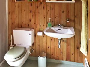 a bathroom with a toilet and a sink at 6 person holiday home in Nexø in Vester Sømarken +15 photos