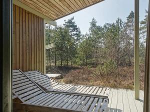 a porch with a bench on the side of a house at 6 person holiday home in Nexø in Vester Sømarken
