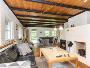 a living room with a couch and a fireplace at 6 person holiday home in Bindslev in Bindslev