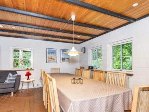 a dining room with a table and chairs at 6 person holiday home in Bindslev in Bindslev +41 photos