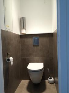 a bathroom with a white toilet in a room at Splendid 0705 in De Panne