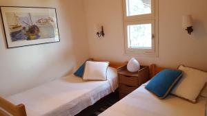 A bed or beds in a room at Seafront Villa Aggeliki