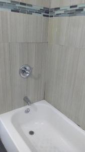 a white bath tub with a sink in a bathroom at Stuart Hotel in Los Angeles