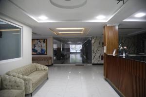 a living room with a couch and a hallway at Nizalia Hotel by Marvelous Holidays in Patriata
