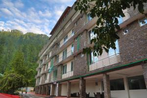 a large building with balconies on the side of it at Nizalia Hotel by Marvelous Holidays in Patriata