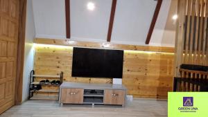 a living room with a flat screen tv on a wall at Green Una Wooden House in Kulen Vakuf