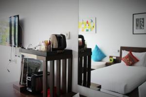 a bedroom with a bed and a table with a mirror at Family House Zen Boutique Resort in Pai