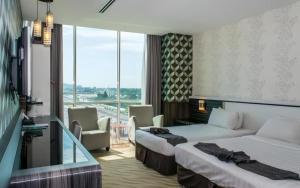a hotel room with two beds and a balcony at MH Hotels Ipoh in Kampong Simee +181 photos