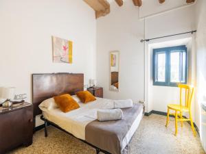 a bedroom with a bed and a desk and a chair at Can Teulera in San Martín Sarroca +74 photos