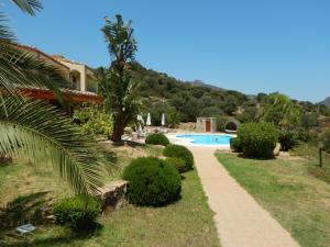 a path leading to a villa with a swimming pool at La Mariachiara in Tertenìa