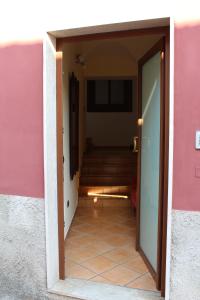 an open door to a hallway with stairs in a house at Ali House in Montecorvino Rovella