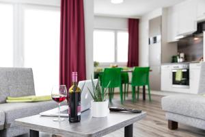 a living room with a table with a glass of wine at Business and Family Homes in Burgau
