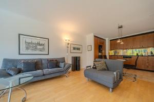 a living room with a couch and a chair at Irmella 39 by Arosa Vacations, mit Pool & Sauna in Arosa