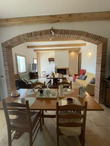 a dining room and living room with a table and chairs at Pasu B&B in Burgos