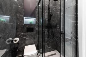 a bathroom with a shower and a toilet at Квартира в стиле лофт in Almaty +59 photos