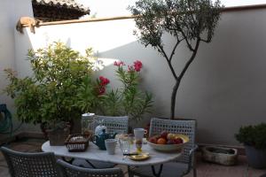 a table and chairs with a bowl of fruit on it at La Remiso in Montfaucon +9 photos