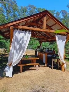a gazebo with a table at Wood Camping in Brochów