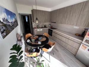 a kitchen with a table and chairs in a room at Apartment with a view of nature in Prievidza