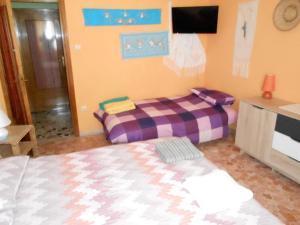 Postel nebo postele na pokoji v ubytování I Tetti Di Sassari B&B
