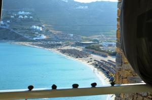 a view of a beach and the ocean from a window at Sea Side Studios & Houses in Kalo Livadi