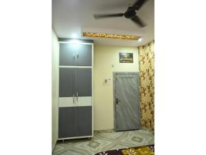 a corridor with a door in a room at Shri Gopinath In in Varanasi +16 photos