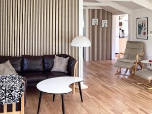 a living room with a couch and a table at 6 person holiday home in Hals in Hals