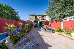 un patio avec des tables et des chaises et un bâtiment dans l'établissement Villa Lupita, à Alquerías del Niño Perdido