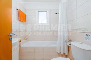 a bathroom with a tub and a toilet and a sink at Apartment Olive in Paralimni +5 photos