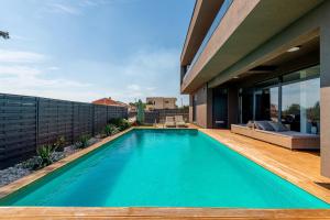 a swimming pool in the backyard of a house at Villa Luxy Luy in Loborika