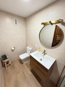 a bathroom with a sink and a mirror and a toilet at Apartamento Sal Marina in Moraira +32 photos