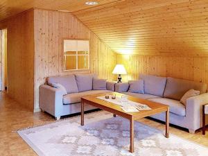 a living room with two couches and a coffee table at 5 person holiday home in Lammhult, Sverige in Förhult +14 photos