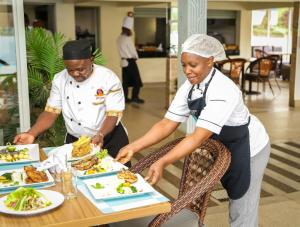 a man and a woman eating food at a table at Methodist Resort in Nairobi