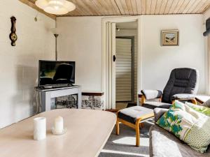 a living room with a couch and a table at 5 person holiday home in Læsø in Læsø