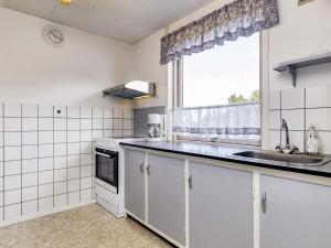 a kitchen with a sink and a window at 6 person holiday home in Læsø in Læsø +21 photos