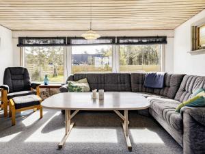 a living room with a couch and a table at 5 person holiday home in Læsø in Læsø