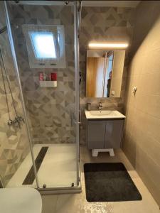 a bathroom with a shower and a sink at Mirador Golf 3 cappuccino in Cabo Negro