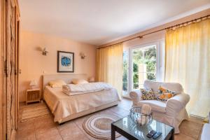 a bedroom with a bed and a couch and a chair at Cote D'azur Villa avec pisicine in Saint-Paul-de-Vence +25 photos