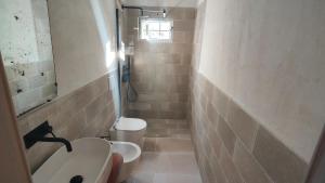 a small bathroom with a sink and a toilet at Lamia Giulia in Ostuni