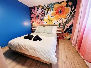 a bedroom with a bed with two black bears on it at Escale Pop Art T3 in Ugine